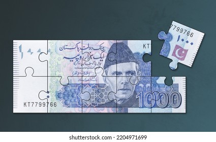 Pakistan One Thousand Rupees note cut into jigsaw puzzle pieces. A conceptual photo for 'Zakat' or almsgiving which is a religious obligation in Islam. - Shutterstock ID 2204971699