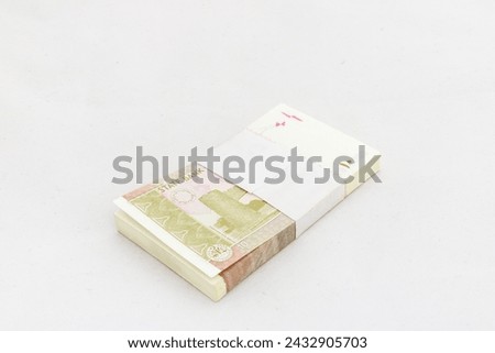 Pakistan ten rupees denomination note bundle on white isolated background