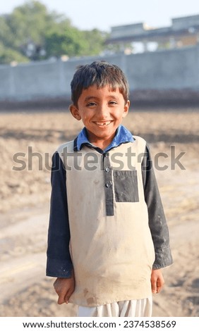 A Pakistani baby boy stylish posing against natural field. Pakistani model baby boy doing stylish poses. Pakistani village baby boy in cultural dress. Portrait of Asian model baby boy. Happy face.