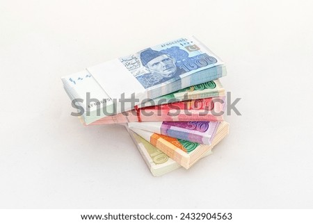 Pakistani currency banknotes bundles on white isolated background