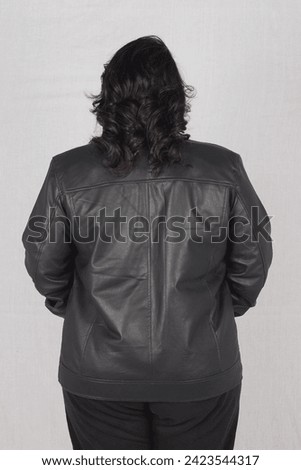 Pakistani female model posing in black leather jacket and black jeans with top 