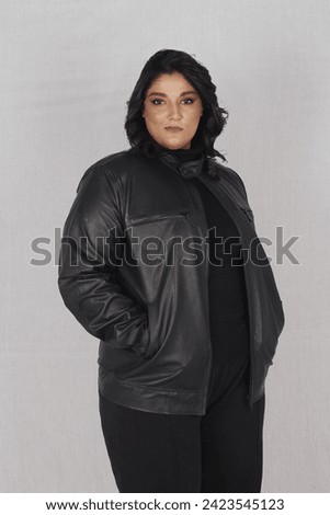 Pakistani female model posing in black leather jacket and black jeans with top 
