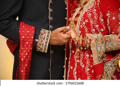 Pakistani Indian Bride And Groom Holding Hand At Their Wedding Day 