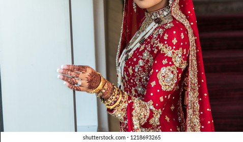 Pakistani Indian Bride Wearing Red Lengha Dress And Wedding Gold Jewellery