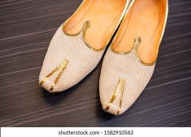 Pakistani  Indian groom wedding cream color and gold mojaris shoes  - Shutterstock ID 1582910563