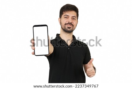 Pakistani or Indian Male. Indian young man in black shirt showing mobile screen. Man Showing Thumbs Up with White Empty Smartphone Screen. Desi Model. Pakistan Model. Mobile Mockup. White background