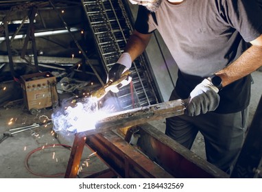 Pakistani Or Indian Professional Welder Worker Welding Metal At Workshop With Electric Welding Rod