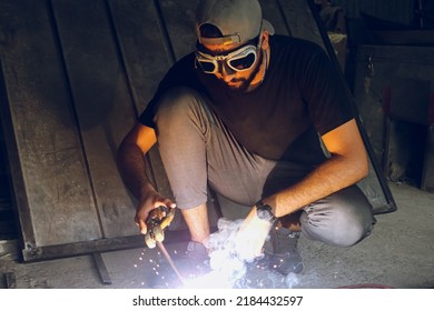 Pakistani Or Indian Professional Welder Worker Welding Metal At Workshop With Electric Welding Rod