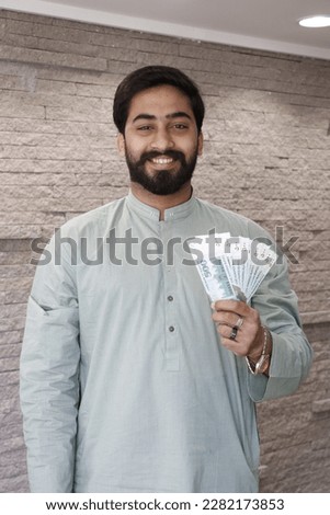 pakistani man showing mobile phone and cash, man showing cash and mobile