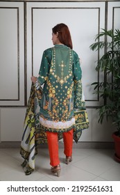 A Pakistani Shalwar Kameez Suit With Dupatta. Pakistani Model Is Shown Her Dress With Style.