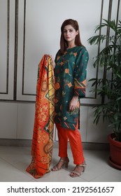 A Pakistani Shalwar Kameez Suit With Dupatta. Pakistani Model Is Shown Her Dress With Style.