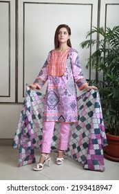 A Pakistani Shalwar Kameez Suit With Dupatta. Pakistani Model Is Shown Her Dress With Style.