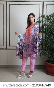 A Pakistani Shalwar Kameez Suit With Dupatta. Pakistani Model Is Shown Her Dress With Style.