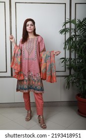 A Pakistani Shalwar Kameez Suit With Dupatta. Pakistani Model Is Shown Her Dress With Style.