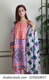 A Pakistani Shalwar Kameez Suit With Dupatta. Pakistani Model Is Shown Her Dress With Style.