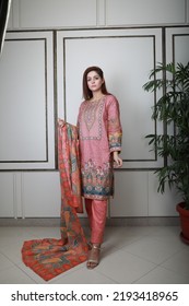 A Pakistani Shalwar Kameez Suit With Dupatta. Pakistani Model Is Shown Her Dress With Style.