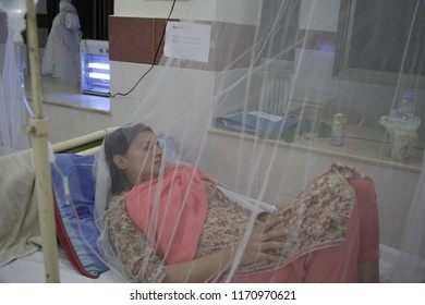 Pakistan-Lahore, A Girl Suffering From Dengue Fever Sits Under A Mosquito Net While Seeking Treatment At A Hospital In Lahore September 17, 2011. 