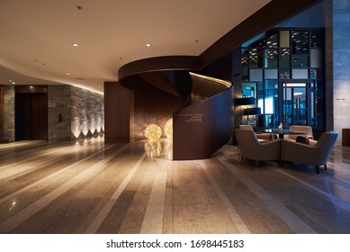 Palace Hotel Hall With A Spiral Staircase And Lights In Ball Shape On The Ground. Modern Space Close To The Entrance. Bürgenstock, Weggis, Switzerland 05/2019