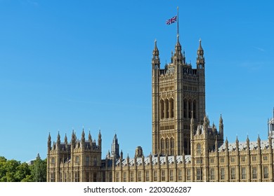 Palace Of Westminster With Union Jack Flag Flying At Half Mast