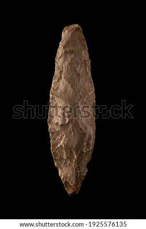 Palaeolithic javelin tip in perfect condition on black background