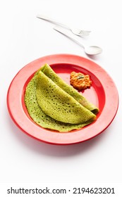 Palak Dosa Made Using Mixing Spinach Or Keerai In Batter, Served With Red Chutney