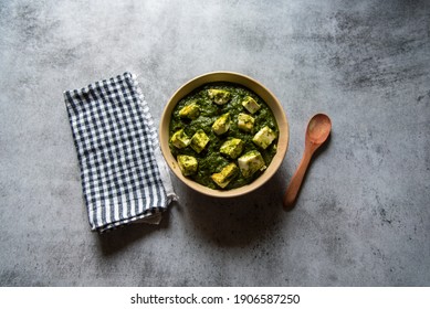 Palak Paneer Or Cottage Cheese Cubes In Spinach Curry With Use Of Selective Focus On A Particular Cottage Cheese Cube With Rest Of The Cubes And Everything Else Blurred. An Indian Delicacy Main Course