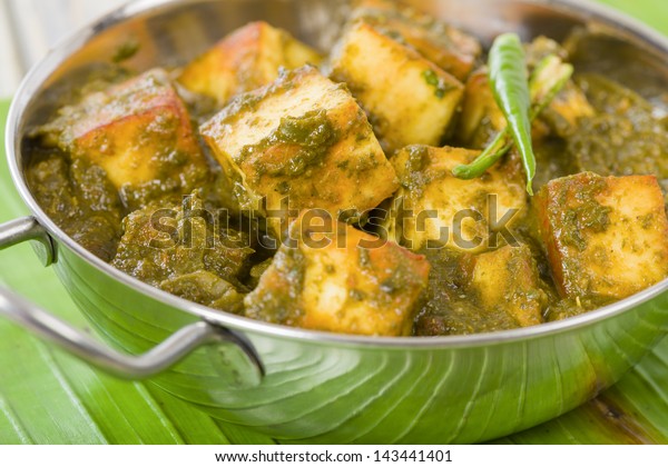 Palak Paneer - South Asian curry made with paneer (cheese) with pureed spinach sauce. Close up.
