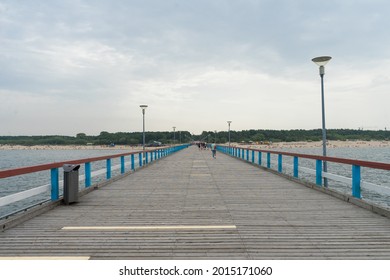 Palanga Lithuania - July 15 2021: Famous long pedestrian sea pier. Wooden bridge stretching into the sea. 