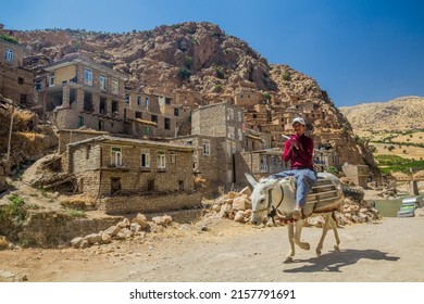 PALANGAN, IRAN - JULY 12, 2019: Donkey rider in Palangan village in Kurdistan region, Iran