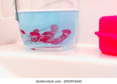 PALATE EXPANDER Of A Girl In A Glass That Is Cleaned With An Effervescent Tablet To Maintain Hygiene.