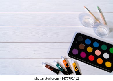 Palate Of Water Color Paint On The White Wooden Table