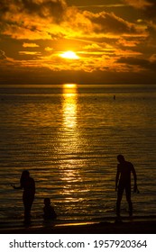 Palau - June 21 2017: Silhouette Of A Family Playing While Waiting For The Sunset On The Beach Of Palau Pacific Resort, Micronesia.