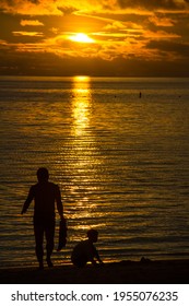 Palau - May 22 2017: Silhouette Of A Family Playing In The Sand On The Beach Of The Palau Pacific Resort, Palau Micronesia.