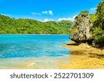 
PALAWAN, PHILIPPINES - DECEMBER 21, 2023: Local traditional outrigger tour boat with tropical islands  in El Nido on Palawan Island in the Philippines. 6 million tourists visited Philippines in 2016.