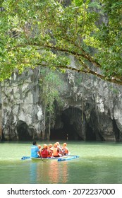 Palawan, Philippines - January 16, 2014 : Some Tourists On Inflatable Boats Going Into The Cave