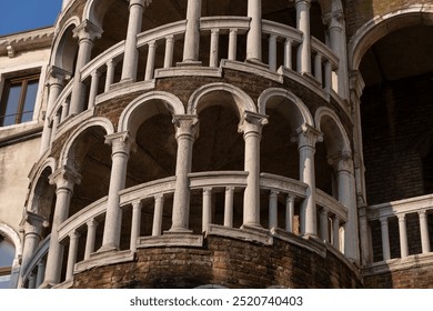 Palazzo Contarini del Bovolo in Venice, Italy. Arched spiral staircase exterior from the 15th century, historic city landmark in San Marco district.