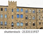 The Palazzo Pretorio under a cloudy sky in the dayime in Volterra, Italy