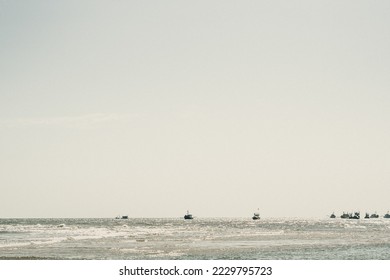 Pale blue gray tone seascape clear sky view. Real nature beauty background. boats sail skyline bay calm ripple sea. Fishing life style. trip leisure travel. Paradise tranquility serenity peace quiet