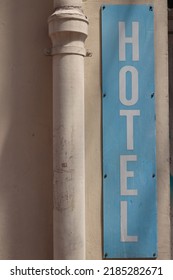 Pale Blue Vintage Hotel Sign Against A Cream Wall