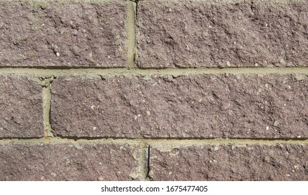 
Pale Brown Bricks With Uneven Chipped Surface And Not Accurate Yellow Seams. Background Close-up.