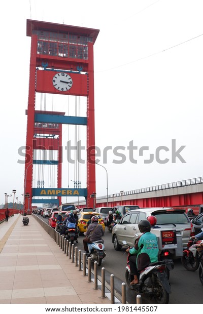 PALEMBANG, INDONESIA - 20-05-2021; In the\
afternoon at the Ampera bridge and the busy traffic is full of\
vehicles. Ampera bridge, South\
Sumatra