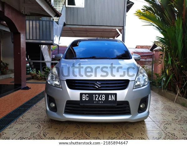 Palembang, Indonesia -\
August 1st, 2022: A silver Suzuki Ertiga car parked in the yard.\
Suzuki Motor Corporation is a Japanese multinational corporation\
headquartered in\
Japan