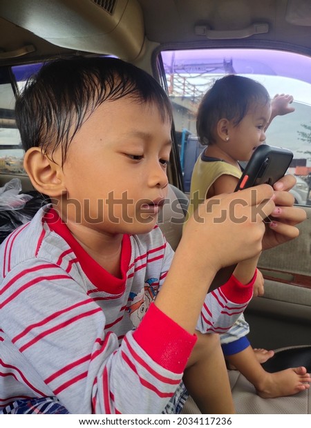 Palembang, Indonesia - August 30, 2021:\
selective focus on indonesian people in the car. real Indonesian\
face. Indonesia, a country with diversity of ethnicity, culture,\
language and\
religions