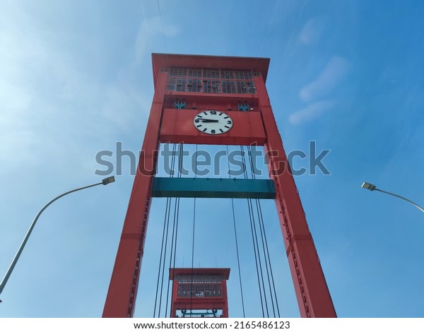PALEMBANG, INDONESIA, June 8, 2022 : In the\
afternoon at the Ampera bridge and the busy traffic is full of\
vehicles. Ampera bridge, South\
Sumatra
