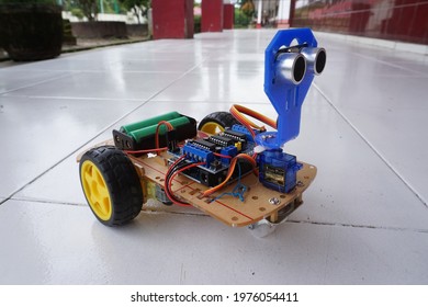 Palembang, Indonesian - April 4, 2021 : A Programmable Two Wheel Drive Robot Car With Obstacle Avoidance With Ultrasonic Sensors And And 18650 Battery, Human Following Robot.