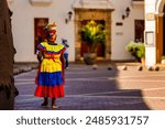 Palenquera woman walks through the streets of the walled city in Cartagena de Indias, Colombia