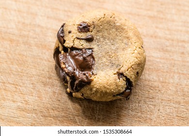 Paleo Chocolate Chip Cookies Made with Coconut and Almond Flour on Wooden Board. Organic Dessert with Melted Chocolate. - Powered by Shutterstock