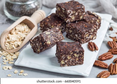 Paleo chocolate energy bars with rolled oats, pecan nuts, dates, chia seeds and coconut flakes, horizontal - Powered by Shutterstock