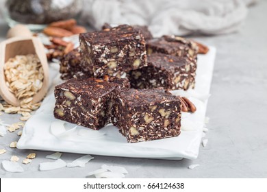 Paleo chocolate energy bars with rolled oats, pecan nuts, dates, chia seeds and coconut flakes, horizontal, copy space - Powered by Shutterstock