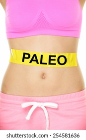 Paleo Diet Concept - Closeup Of Woman's Stomach To Show Eating Concept. New Trend In Nutrition Based On Hunter Gatherer Consumption Of Proteins. Yellow Label As Warning Or Caution Applied On Body.